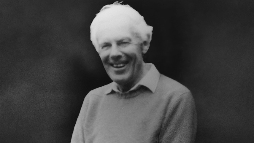 Black and white image of Director DSD, Robert ‘Bob’ Botterill smiling.