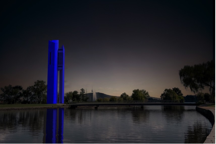 The National Carillon lit up blue, on Aspen Island, Lake Burley Griffin (National Capital Authority)