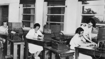 WRANS telegraphists at work on morse code communications equipment at HMAS Harman 1955
